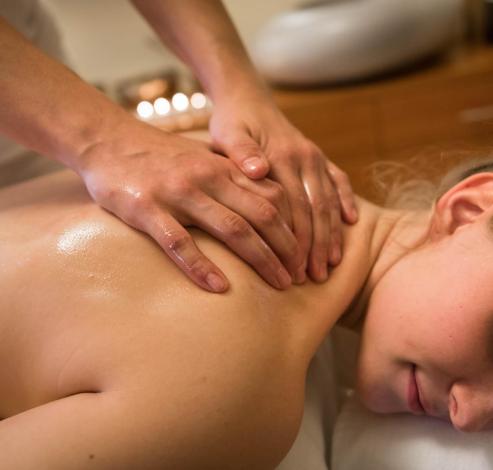 A woman receives a back massage